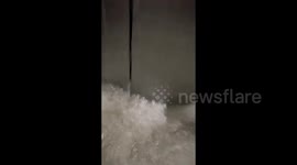 Terrifying moment mother and daughter trapped in elevator as floodwaters surge in China