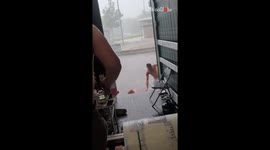 Intense storm turns comical as man falls out of trailer trying to help friend