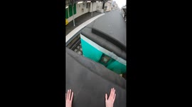 man sneaks on top of train and rides the roof around the city