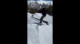 snowboarder slides on a rail directly into a skiier