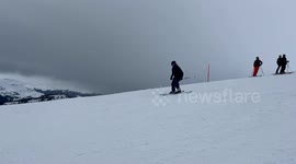 skier slides and fails onto a long green rail