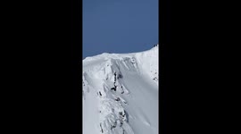 skier hits massive double backflip off a mountain peak and cornice