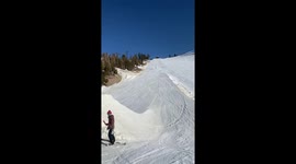 snowboarder launches off a big jump and lands on his back