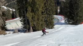 snowboarder goes off jump and runs straight into a skier in all blue
