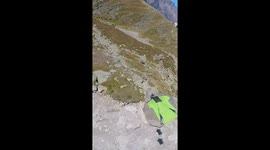 wingsuit flyer fims another wingsuit flyer through a crazy narrow canyon