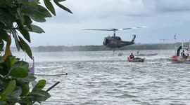 Helicopter collects water to dump on fires in the Philippines