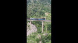 Chinese workers install rockfall protection nets amid flood season