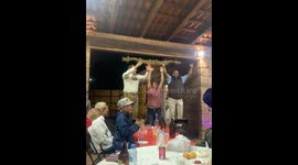 Man falls during family celebration while grabbing a wooden hanging