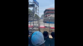 Race car crashes into barrier in front of crowd