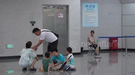 China: Citizens Cool Off at A Rail Transit Platform in Chongqing