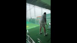 Golfer accidentally hits ceiling while playing at driving rage