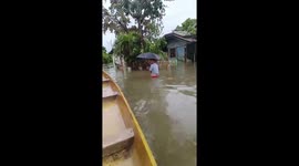 Residents use boats to navigate flooded streets in Calumpit, Bulacan