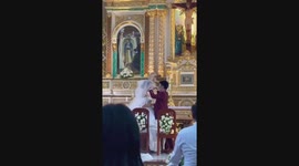 Short groom hilariously uses chair for first kiss with bride at wedding
