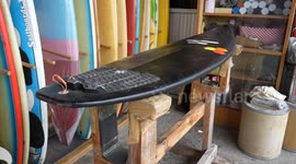 Shop sells old surf boards with custom decorations in urban jungle Bangkok