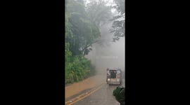 Drivers stranded as waterfall cascades into road in the Philippines