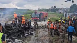 Rescue teams inspect smoking wreckage of plane that crashed during takeoff in Nepal