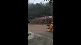 Flood flows into road while motorists rush to go home during typhoon Gaemi