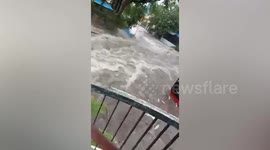 Families stranded as raging flood submerges street during typhoon Gaemi