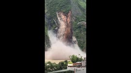 Mud and trees plunge down mountainside, sending smoke into air in southern China