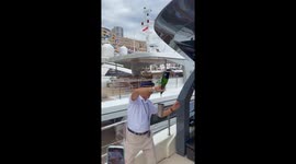 Cheerful bartender in Monte Carlo appears to make cup float