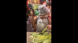 Child's 'behind the scenes' silliness with plastic knife