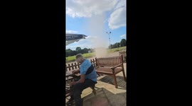 Dust devil casually spins past the pub whilst onlookers can’t believe what they are seeing