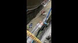 Hero pet owner carries two dogs on his shoulders through floods