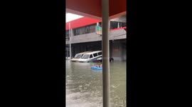 Person enjoys flood waters on inflatable raft amidst typhoon Gaemi in Quezon City, Philippines