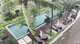 Dive into a unique experience as we take a refreshing swim in the pool, even as the rain gently falls.