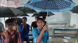 Students forced to use umbrellas in classrooms as deluge hits central India