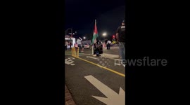 USA: A Palestine supporter watches the protest on the Watergate Hotel side of street