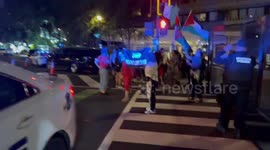 USA: A group of Palestine supporters walk across to the Watergate Hotel side of street to protest