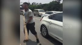 Chinese motorist smashes another driver's car window with huge stick in road rage shocker
