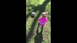 Cute Toddler tries to pick up a soccer ball