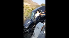 Car crash, truck dangling from cliff with driver inside