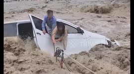 Heroic Chinese police rescue motorists trapped in car stranded by raging floods