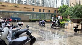 China: A Courier delivers food during heavy rain in Changzhou