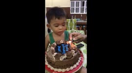 Three-year-old Carlo rushes through birthday song to blow out a candle