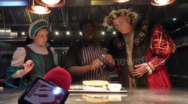 Horrible Histories Terrible Tudors stars Neal Foster and Emma Swan in character watch pie go in the oven.