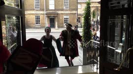 Horrible Histories Terrible Tudors stars Neal Foster and Emma Swan in character enter the hotel.