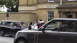 Horrible Histories Terrible Tudors stars Neal Foster and Emma Swan in character walk towards the Royal Mews