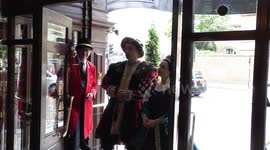 Horrible Histories Terrible Tudors stars Neal Foster and Emma Swan in character pose at the hotel door.