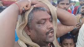 Locals wrap snakes around their NECKS in bizarre fair in northern India