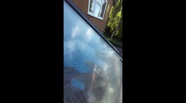 Majestic early morning reflection revealed as man magically cleans window