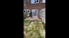 Pressure washing an overgrown patio reveals its true beauty