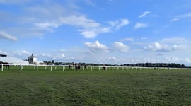 Two horses finishing a race York racecourse England UK