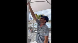 Man takes matters into his own hands when an umbrella is needed on vacation