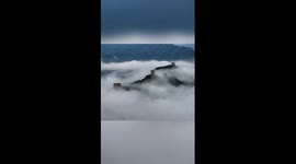 Beautiful drone footage of sea of clouds shrouding Great Wall in China