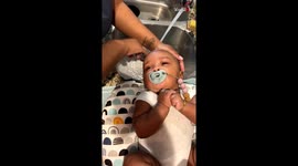 Baby enjoys a luxurious spa-like hair wash as grandma gently scrubs her scalp