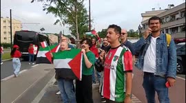 Protesters in Le Plessis-Robinson wave Palestinian flags as Olympic flame passes